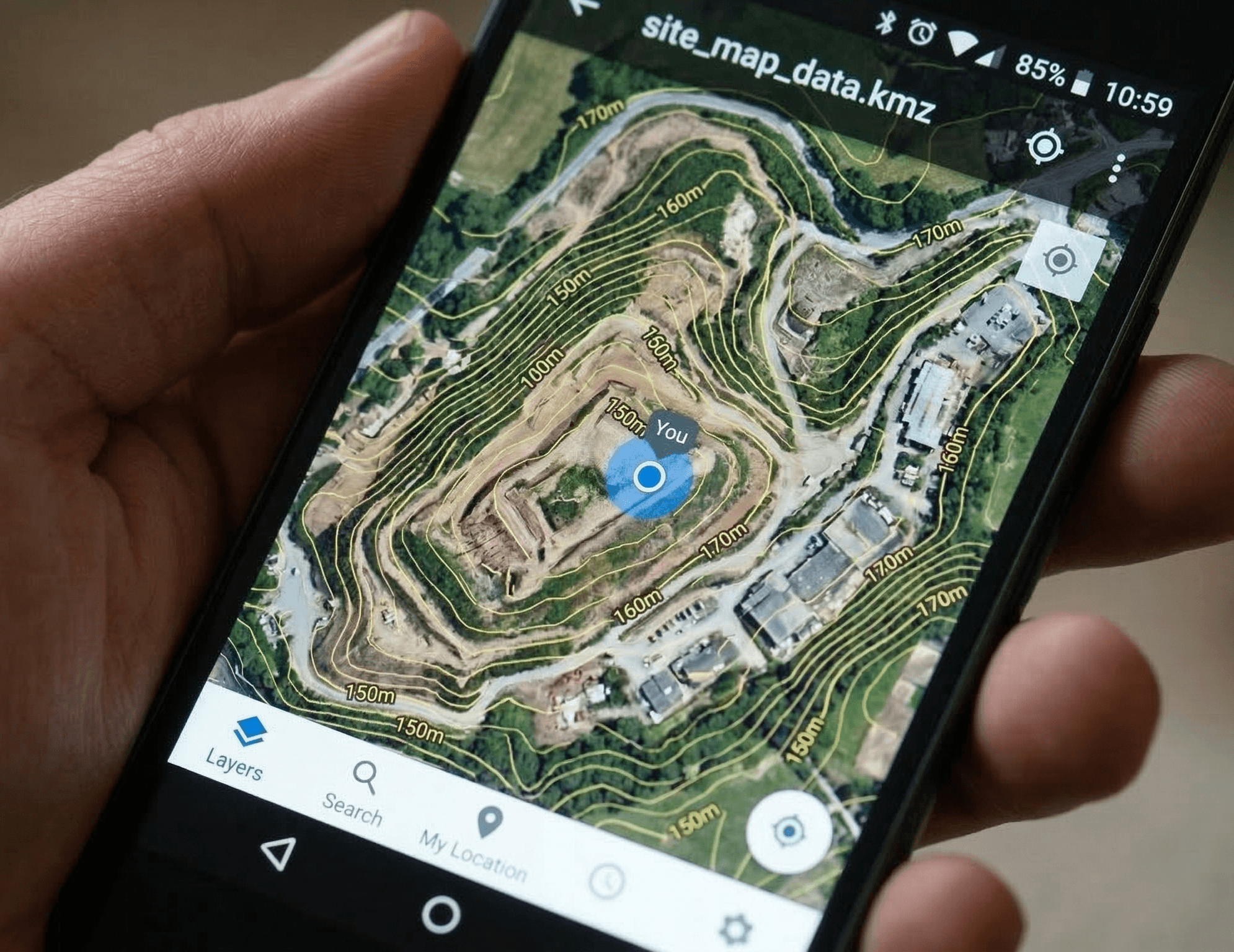 A detailed close-up of a mobile smartphone screen displaying a georeferenced .KMZ file with topographical contours and elevation labels overlaid on a high-resolution drone orthomosaic, synchronized to the user’s real-time GPS position.